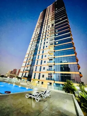 a tall building with a pool in front of it at Modern Studio With Scenic Views in Dubai