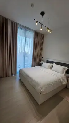 a bedroom with a large bed and a large window at LAREDA BY VIBY Vacation Homes Rental in Dubai