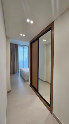 a room with a mirror and a bed in it at LAREDA BY VIBY Vacation Homes Rental in Dubai
