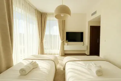 a hotel room with two beds and a television at Luxurious Apartment with Burj Khalifa View in Downtown in Dubai