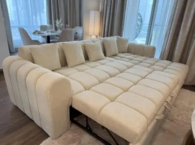 a large white couch in a living room at Luxurious Apartment with Burj Khalifa View in Downtown in Dubai