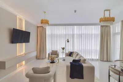 a living room with a couch and two chairs at Luxe 2 Bedroom Apartment in Dubai Marina in Dubai