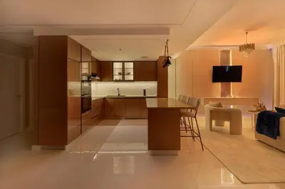 a kitchen and living room with a table and a couch at Luxe 2 Bedroom Apartment in Dubai Marina in Dubai