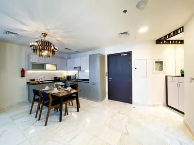a kitchen and dining room with a table and chairs at Elegant 1BDR Sleeps 4 in Bayz-22 in Dubai