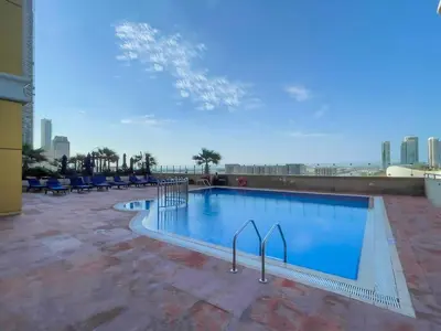 a swimming pool on the roof of a building at Cozy 1BR Apartment at Elite Residence Dubai Marina in Dubai