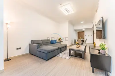 a living room with a couch and a table at Compact 1BR, Just A Minute Drive to At the Top Burj Khalifa - Ontario Tower, Business Bay in Dubai
