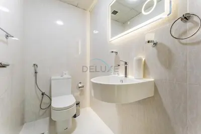 a bathroom with a sink and a toilet and a mirror at Compact 1BR, Just A Minute Drive to At the Top Burj Khalifa - Ontario Tower, Business Bay in Dubai