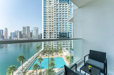 a view from the balcony of a building with a swimming pool at PVH - Damac Maison Prive - Studio with Canal and Pool View in Dubai