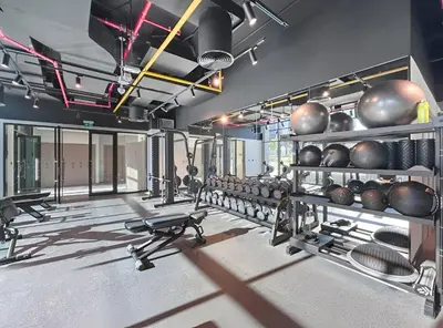 a fitness room with a bunch of equipment in it at Stylish 1BR Apartment Peninsula One Business Bay in Dubai