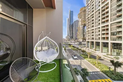 a balcony with chairs and a view of a city at Stylish 1BR Apartment Peninsula One Business Bay in Dubai