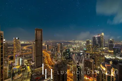 a view of a city at night with buildings at LUX 2BR High Floor - Near Dubai Mall in Dubai