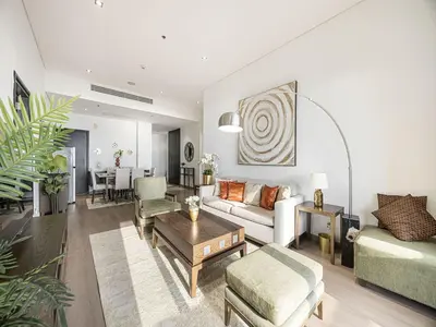 a living room with a couch and a table at Livin' Holidays - 2 BR - Anantara Beach View in Dubai