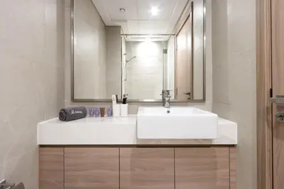 a bathroom with a white sink and a mirror at Bright Studio with Balcony Close to Downtown Dubai in Dubai