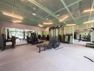 a gym with several treadmills and machines in a room at Mystic - Luxe 1BR Apt with Burj Khalifa & Canal Views in Dubai