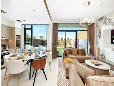 a kitchen and living room with a table and chairs at Luxury 4BR Villa in Arabian Ranches 3, Resort-Style Living with Private Garden & Hot Tub in Nadd Shubayḩ