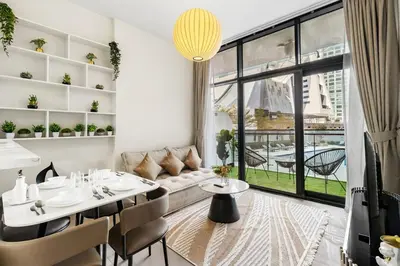 a living room with a table and a couch at Modern 1BR Apartment in DAMAC Merano Business Bay in Dubai