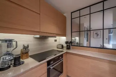 a kitchen with wooden cabinets and a counter top at Murjan 2702 in Dubai