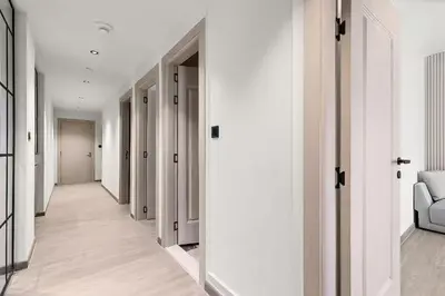 a hallway with white walls and white doors at Murjan 2702 in Dubai