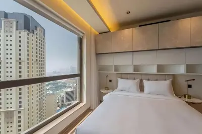 a bedroom with a large white bed and a large window at Murjan 2702 in Dubai