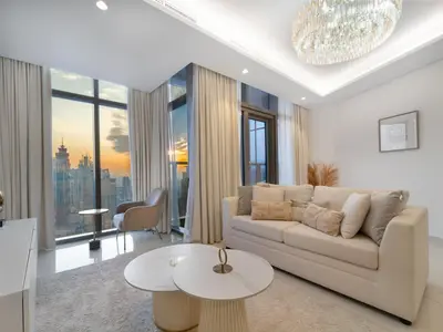 a living room with a couch and a table at Luxury 1BR High floor Paramount Midtown in Dubai