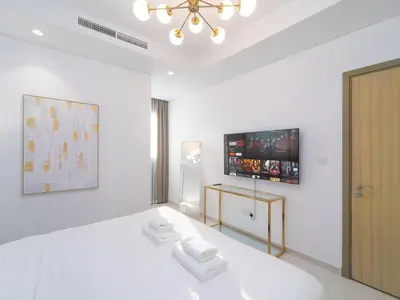 a white room with a television on the wall at Luxury 1BR High floor Paramount Midtown in Dubai