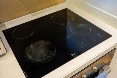 a black stove top oven sitting on top of a counter at BurjKhalifaViews,1BHK, High Floor, Damac Paramount Tower B in Dubai