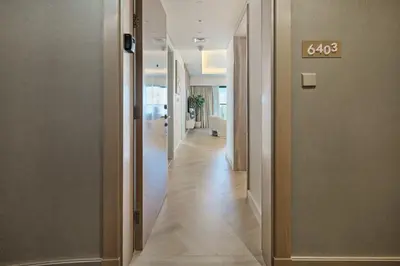 a hallway with a door with the number on it at BurjKhalifaViews,1BHK, High Floor, Damac Paramount Tower B in Dubai