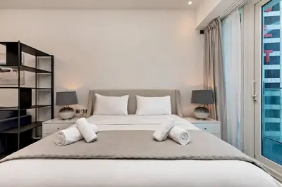 a bedroom with a large bed with white pillows at Chic Studio in Me Do Re JLT YOLO in Dubai