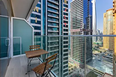 a balcony with a table and chairs on a building at Chic Studio in Me Do Re JLT YOLO in Dubai