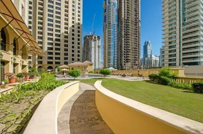 a park in the middle of a city with tall buildings at StayShort - Cozy Relaxing Studio in JBR - Walk to the Beach in Dubai