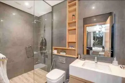 a bathroom with a toilet and a sink and a shower at StayShort - Cozy Relaxing Studio in JBR - Walk to the Beach in Dubai