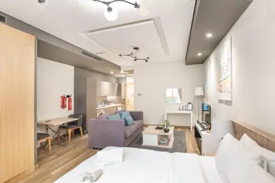 a room with a bed and a living room at StayShort - Cozy Relaxing Studio in JBR - Walk to the Beach in Dubai