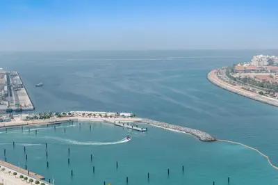 an aerial view of a harbor with a boat in the water at Silkhaus 1BDR in Marina Vista Tower Private Beach in Dubai