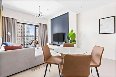a living room with a table and a couch at Silkhaus Prime 1BDR in Burj Royale in Dubai