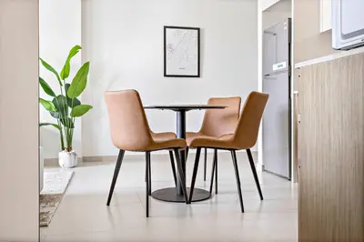 a dining room with a table and two chairs at Silkhaus Prime 1BDR in Burj Royale in Dubai