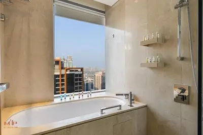 a bath tub in a bathroom with a large window at Luxury 1 Bed in Marina Mall JW Marriot in Dubai