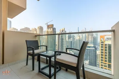 two chairs and a table on a balcony with a view at Luxury 1 Bed in Marina Mall JW Marriot in Dubai