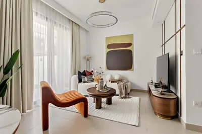 a living room with a couch and a table at Silkhaus Spacious 3BDR & Maid Tilal Al Ghaf in Dubai