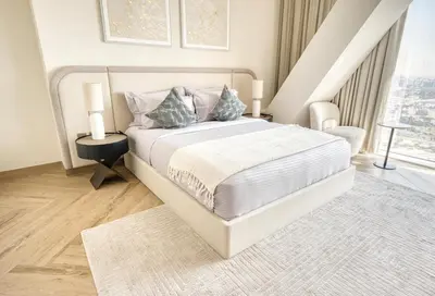 a white bedroom with a bed and a window at Upscale Modern 2-Bedroom with Elegant Interiors in Dubai