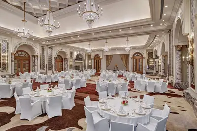 a ballroom with white tables and chairs and chandeliers at Al Habtoor Palace - Preferred Hotels & Resorts in Dubai