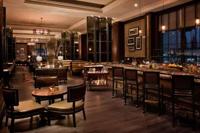 a restaurant with tables and chairs and a bar at Al Habtoor Palace - Preferred Hotels & Resorts in Dubai