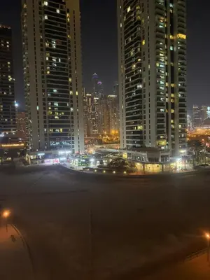 a city lit up at night with tall buildings at 403,1 BHK lake View, V3 tower, JLT Royal Montania in Dubai