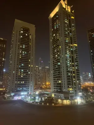 a city skyline at night with tall buildings at 403,1 BHK lake View, V3 tower, JLT Royal Montania in Dubai