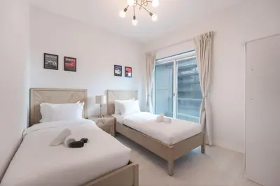 a bedroom with two beds and a window at StayShort - Stlylish 2 Bedroom in Dubai Marina that Sleeps 4 Near Metro in Dubai