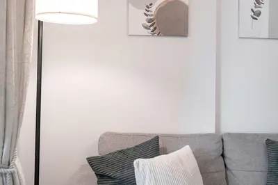 a living room with a gray couch and a lamp at StayShort - Stlylish 2 Bedroom in Dubai Marina that Sleeps 4 Near Metro in Dubai