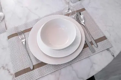a table with a white plate and fork and knife at StayShort - Stlylish 2 Bedroom in Dubai Marina that Sleeps 4 Near Metro in Dubai