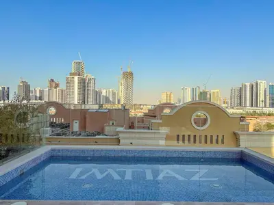 a swimming pool on the roof of a building with a city at FIRST CLASS 1BR Pearl House Elegance in Dubai