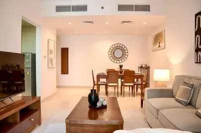 a living room with a couch and a table at Stylish 1BR close to Metro and Dubai Marina in Dubai