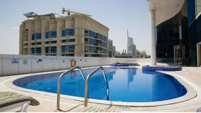 a large swimming pool in front of a building at Stylish 1BR close to Metro and Dubai Marina in Dubai