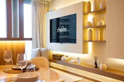 a dining room with a table and a television at Modern and Stylish 2-BR High Floor All Bills Included in Dubai